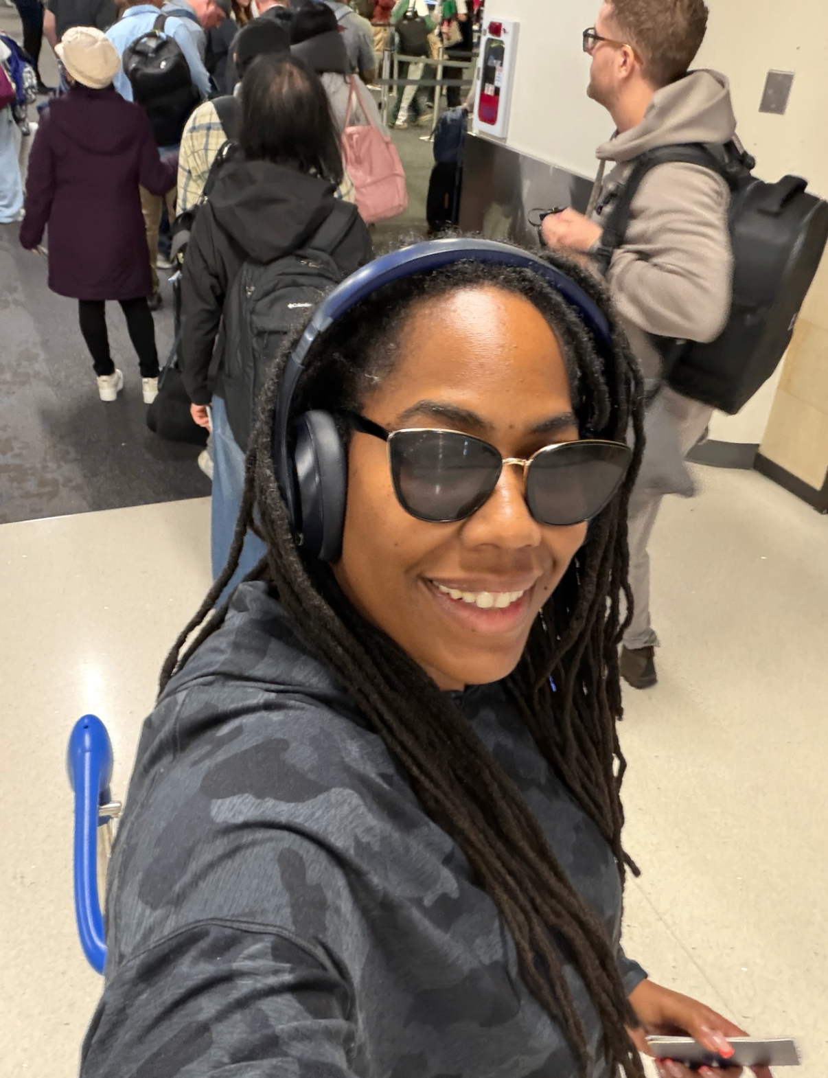 Carmelle traveling through an airport at the start of a new chapter