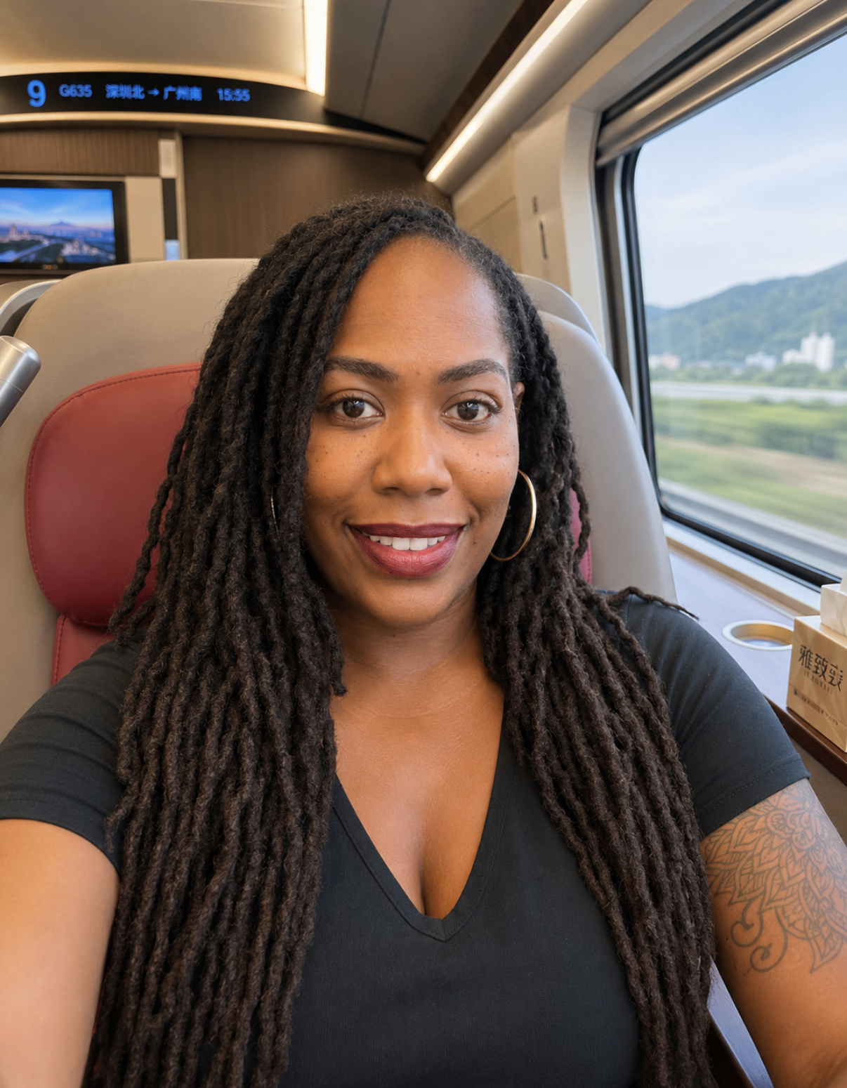 Carmelle seated on a high-speed train, reflecting on the journey ahead