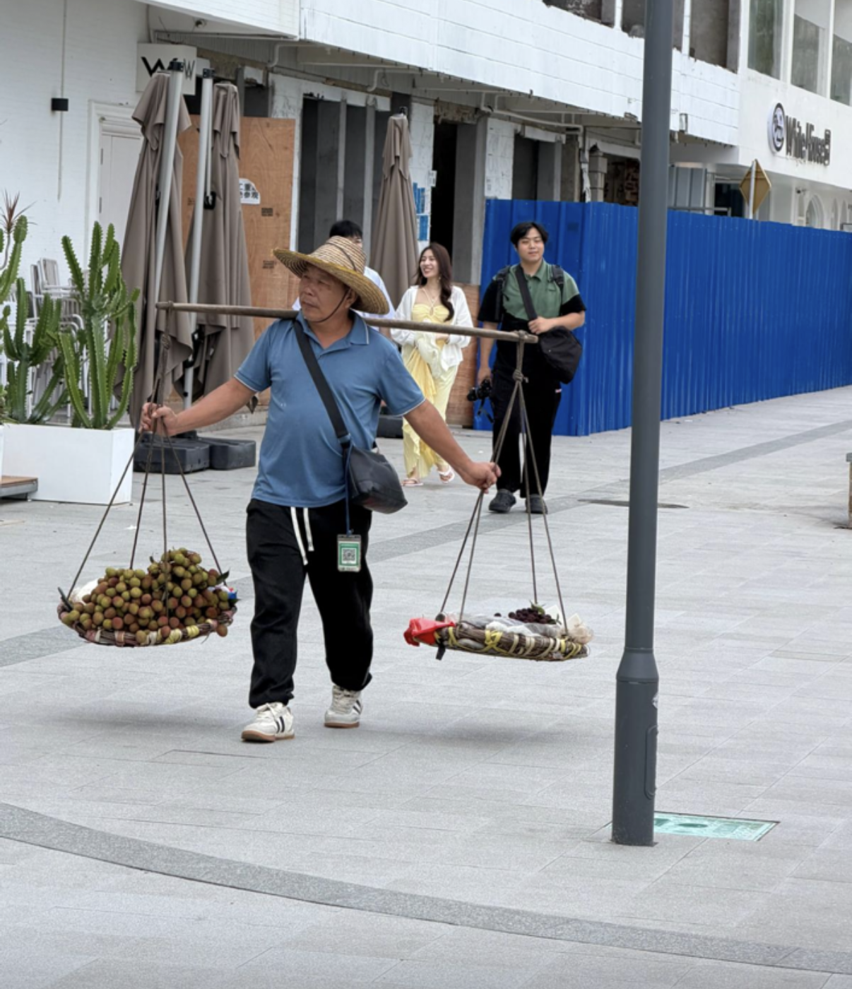 A street vendor carrying fruit, illustrating resourcefulness and everyday enterprise